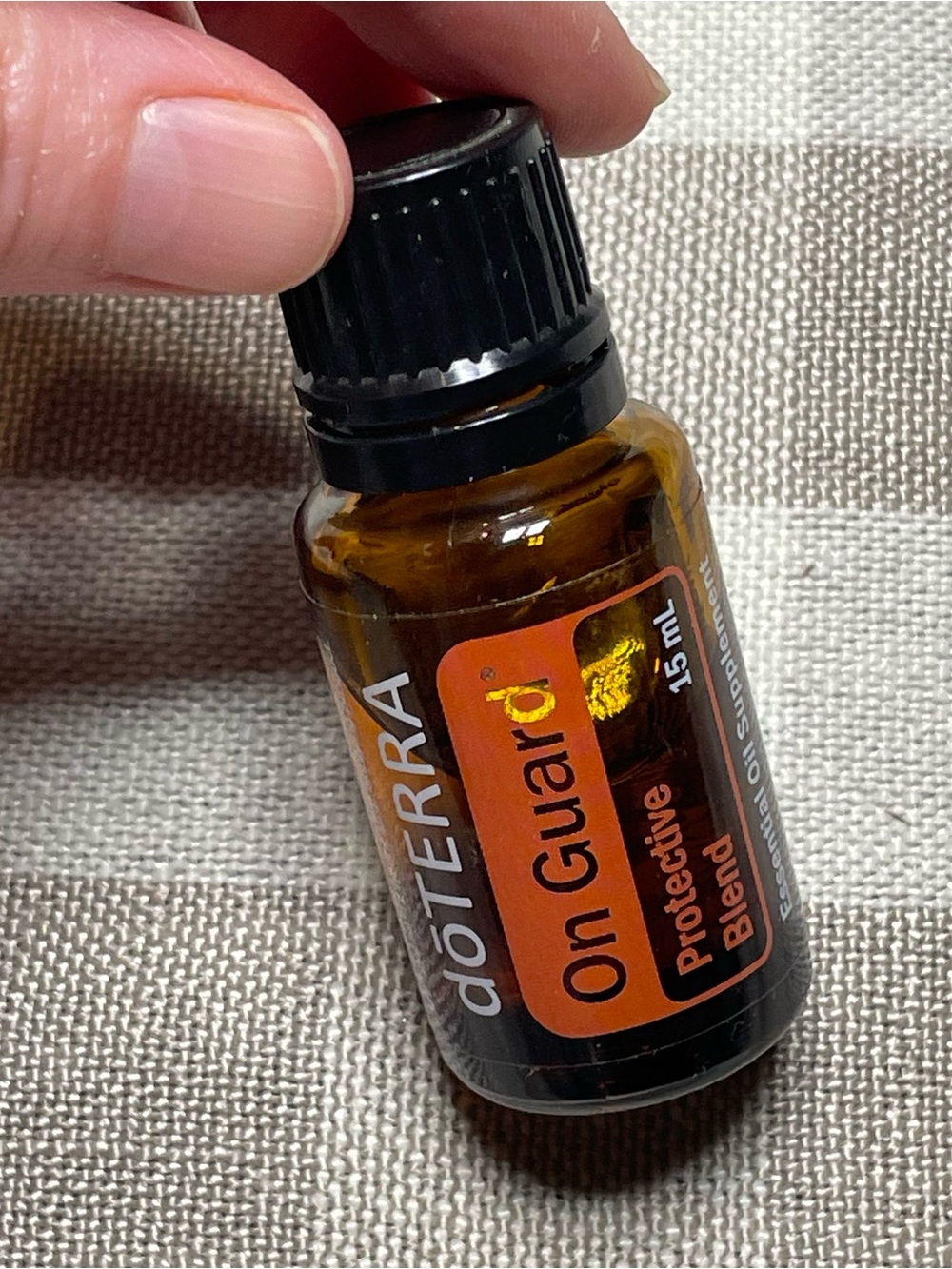 Doterra On Guard Essential Oil Bottle with Orange Label and Black Cap